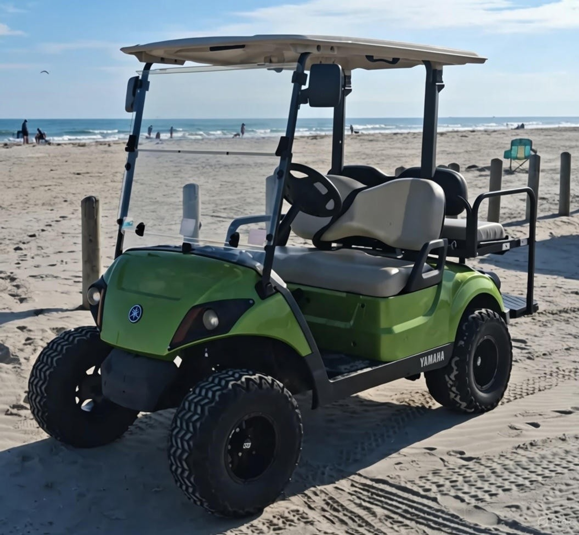 Green Yamaha 4-passenger cart on the Port Aransas beach