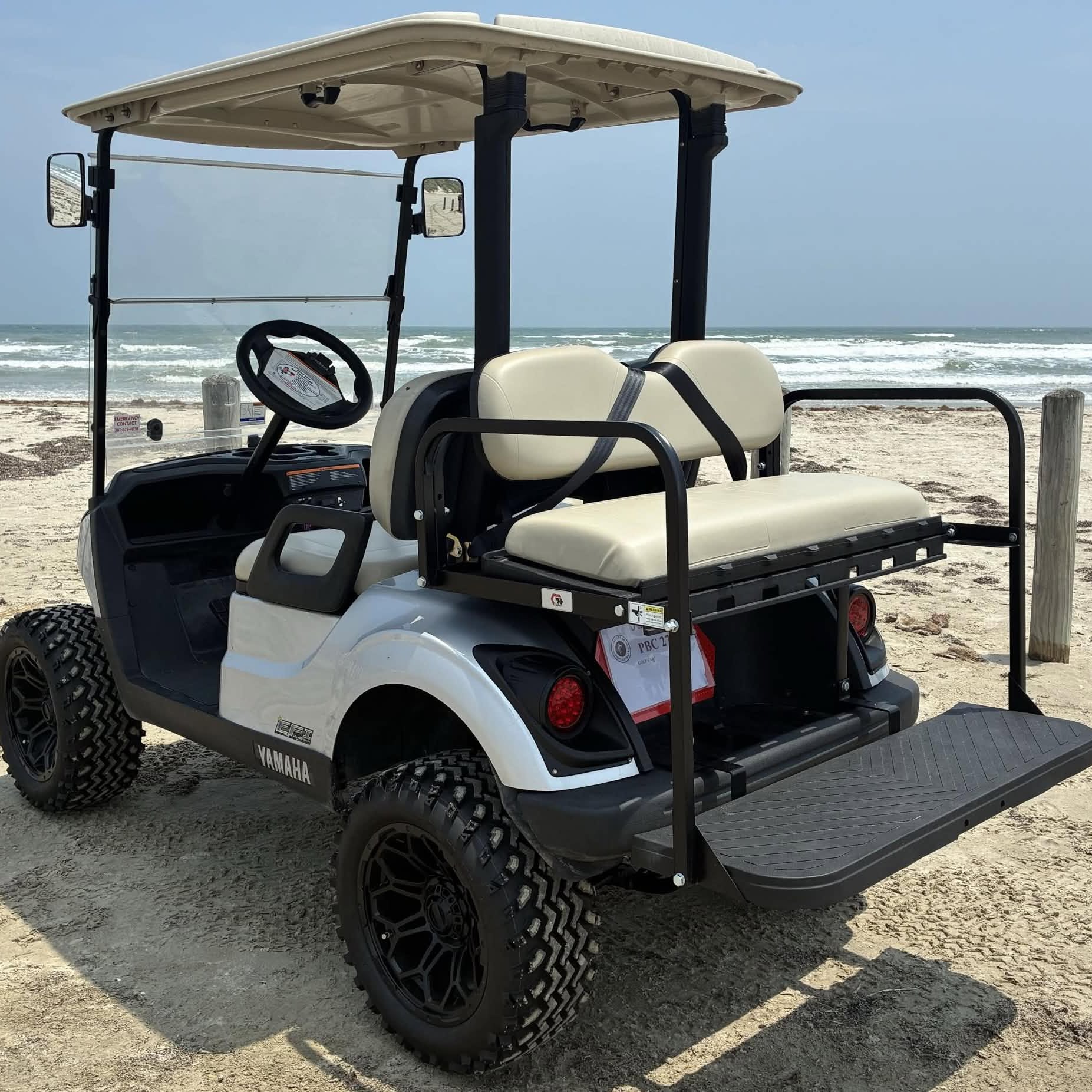 White Yamaha 4-passenger cart with PBC 27 tag at the Port Aransas surf