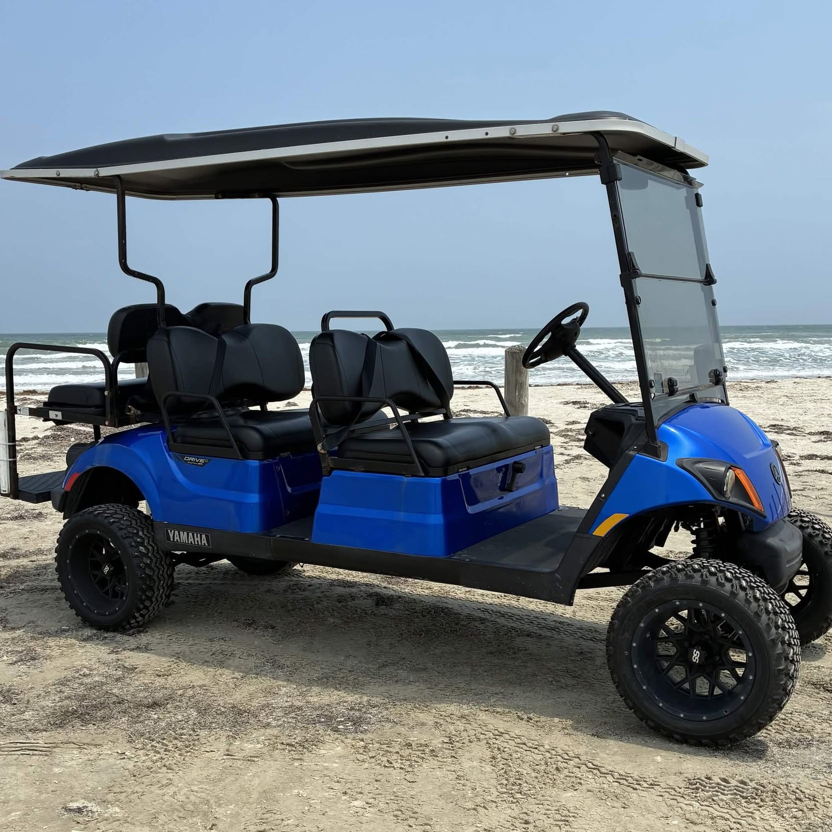 Metallic royal-blue Yamaha 6-passenger cart on the Port Aransas beach