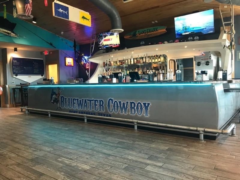 The third-floor boat bar at BlueWater Cowboy — the sportfishing-transom bar on Beach St